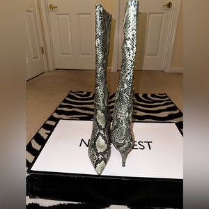 Brand new. Nine West black and ivory snake skin knee high boot. Brand new. Sz 10